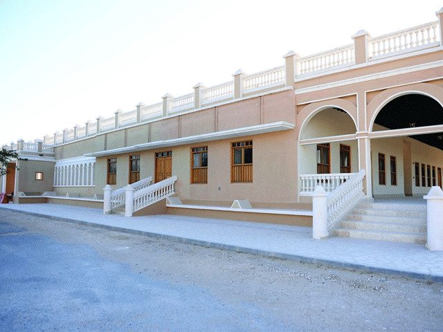 Restored palace building with arched verandah at Al Kharaan
